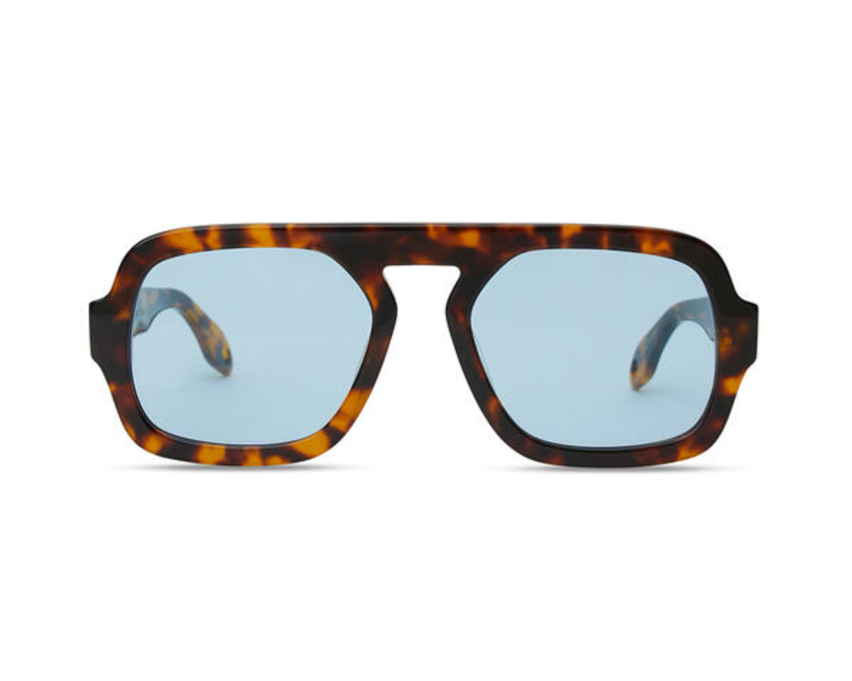 A pair of oversized square sunglasses with a dark brown and amber tortoiseshell frame and light blue lenses, shown against a plain white background.